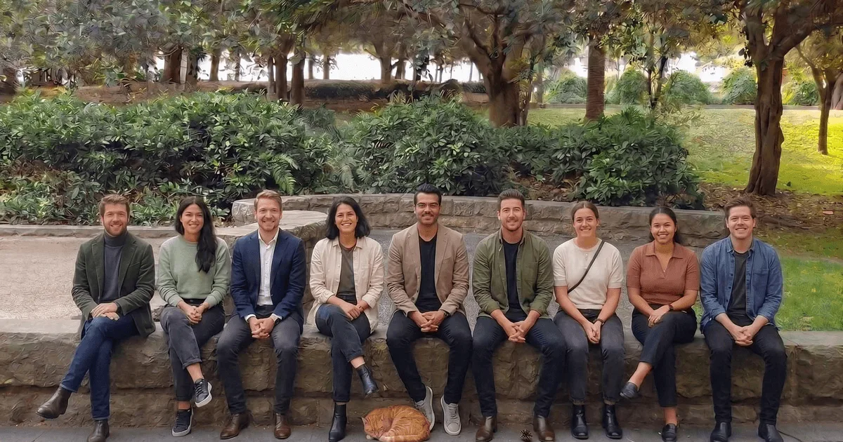 Digital Heroes Sydney team on a stone bench in a Sydney inner-city park